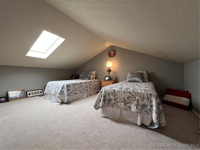 bedroom with lofted ceiling with skylight, a textured ceiling, and carpet flooring