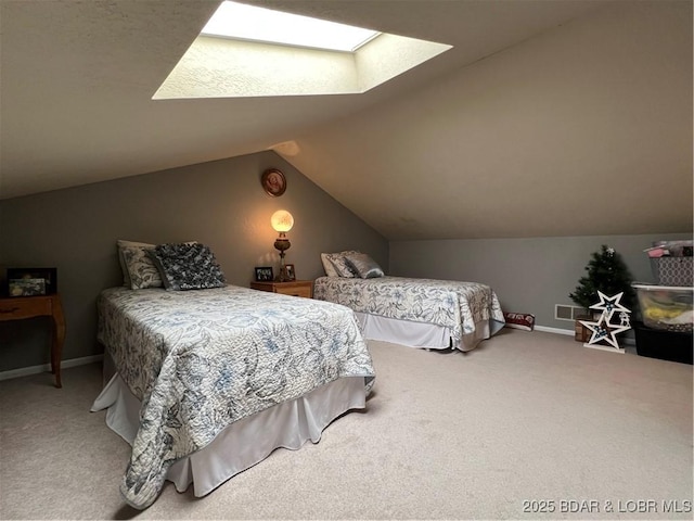 bedroom featuring visible vents, carpet floors, baseboards, and vaulted ceiling with skylight