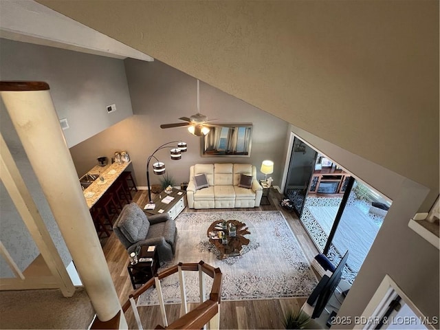 bedroom with high vaulted ceiling and wood finished floors