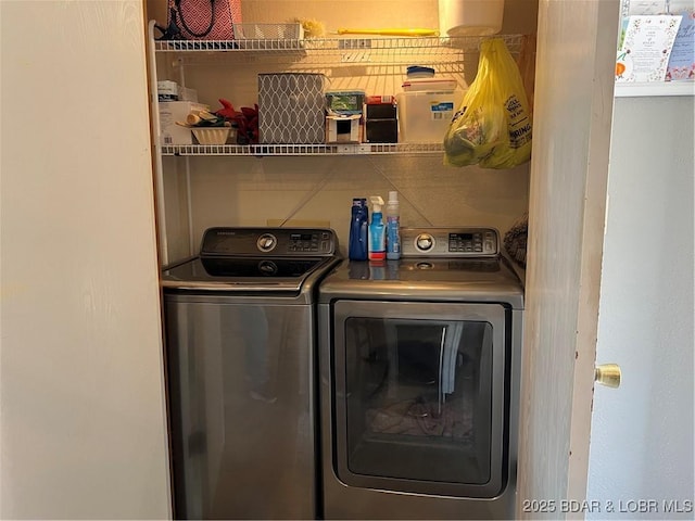 washroom featuring washer and clothes dryer and laundry area