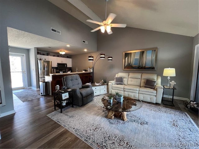 living room featuring visible vents, dark wood-style floors, baseboards, ceiling fan, and vaulted ceiling