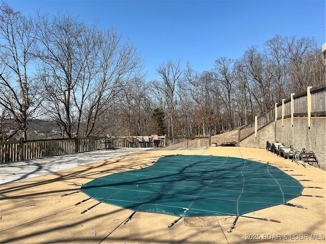 view of swimming pool with fence