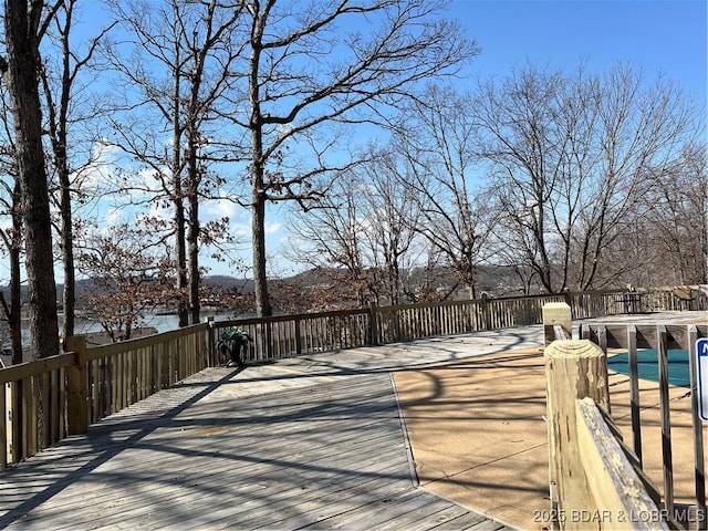 wooden deck with a pool