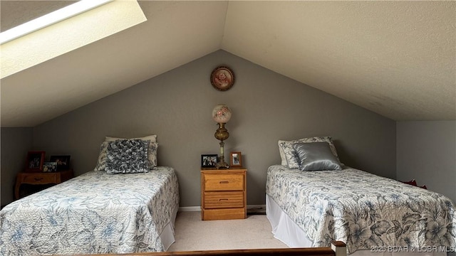 bedroom with vaulted ceiling, baseboards, and carpet floors