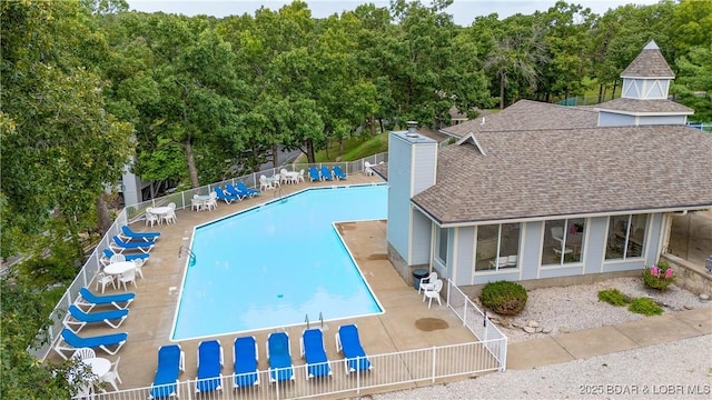 community pool featuring a patio area and fence