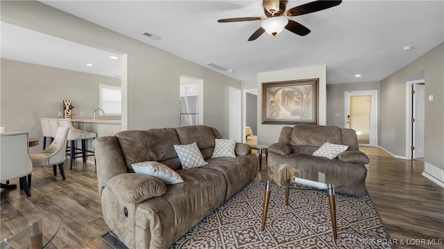 living area with visible vents, a ceiling fan, wood finished floors, recessed lighting, and baseboards