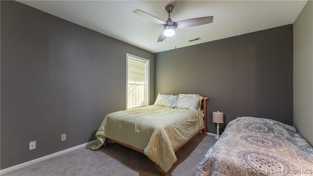 carpeted bedroom with visible vents, ceiling fan, and baseboards