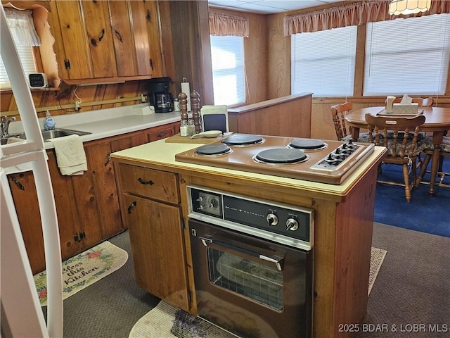 33 Zebco Ct, Edwards, MO 65326 - kitchen featuring brown cabinetry, a sink, oven, light countertops, and electric cooktop