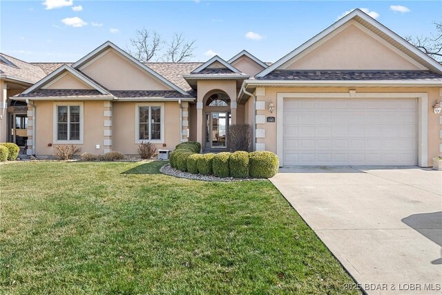 145 Bella Terra Ct, Sunrise Beach, MO 65079 - ranch-style house featuring a front yard, roof with shingles, driveway, an attached garage, and stucco siding