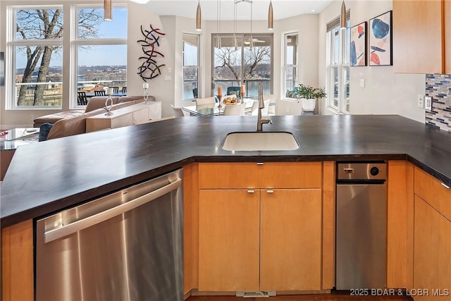 145 Bella Terra Ct, Sunrise Beach, MO 65079 - kitchen featuring stainless steel dishwasher, dark countertops, open floor plan, and a sink