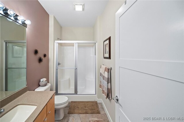 145 Bella Terra Ct, Sunrise Beach, MO 65079 - bathroom featuring toilet, a stall shower, and vanity