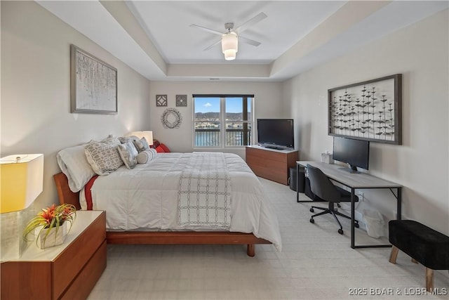 145 Bella Terra Ct, Sunrise Beach, MO 65079 - bedroom featuring a raised ceiling and a ceiling fan