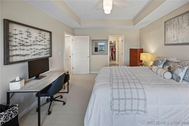 145 Bella Terra Ct, Sunrise Beach, MO 65079 - bedroom with baseboards, carpet floors, a tray ceiling, ceiling fan, and a walk in closet