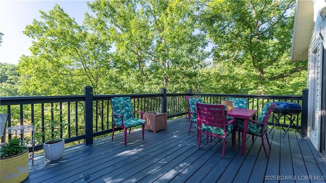 deck with outdoor dining area