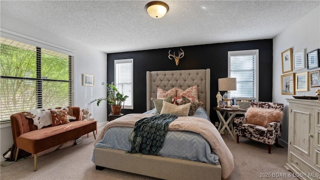 bedroom featuring light colored carpet, a textured ceiling, and multiple windows