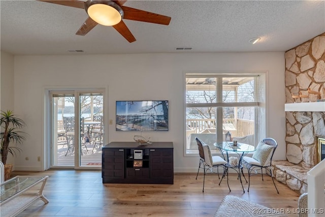889 Malibu Rd Unit 91, Osage Beach, MO 65065 - living area with a textured ceiling, healthy amount of natural light, a ceiling fan, and light wood-style floors