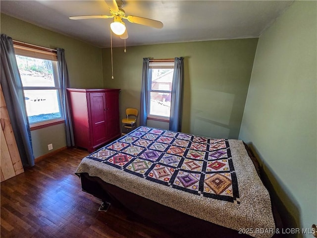 bedroom featuring baseboards, dark wood-style flooring, and ceiling fan