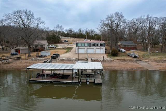 dock area with boat lift and a water view