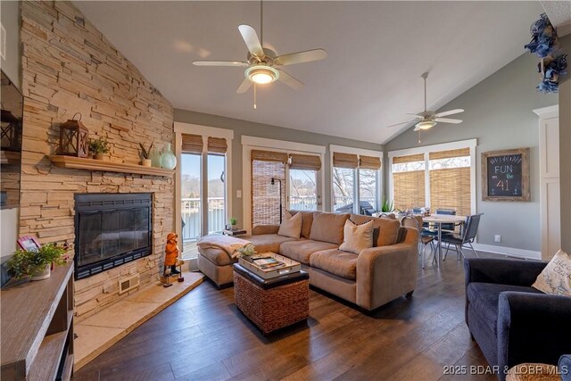2813 Great Lake View Dr, Gravois Mills, MO 65037 - living area with a ceiling fan, dark wood-style flooring, high vaulted ceiling, and a stone fireplace