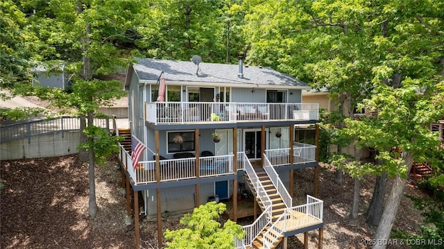 2813 Great Lake View Dr, Gravois Mills, MO 65037 - rear view of property with stairs, roof with shingles, and a view of trees