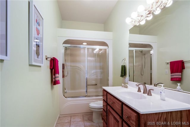 bathroom with tile patterned floors, combined bath / shower with glass door, toilet, and vanity
