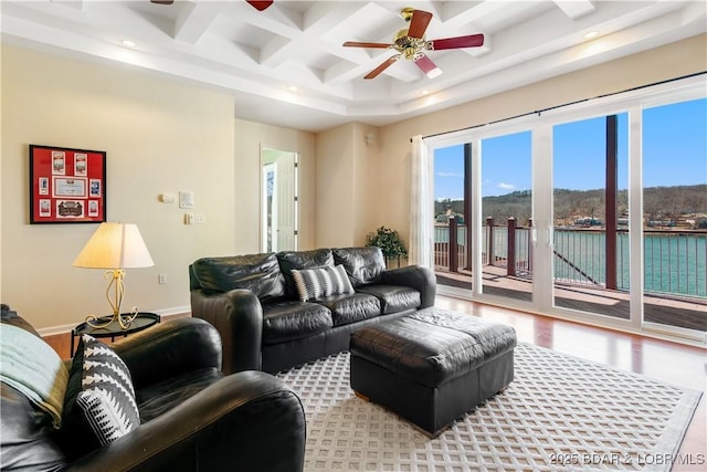 living room featuring baseboards, ceiling fan, beamed ceiling, wood finished floors, and coffered ceiling