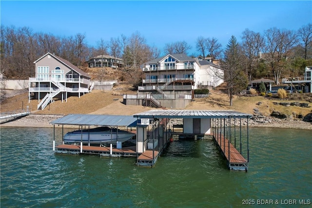 dock area with boat lift and a water view