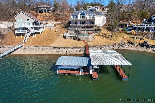 dock area with stairway and a deck with water view