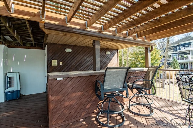 deck featuring outdoor dry bar and a pergola