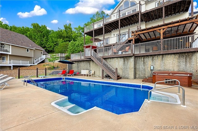view of pool with a fenced in pool, a hot tub, fence, stairs, and a patio