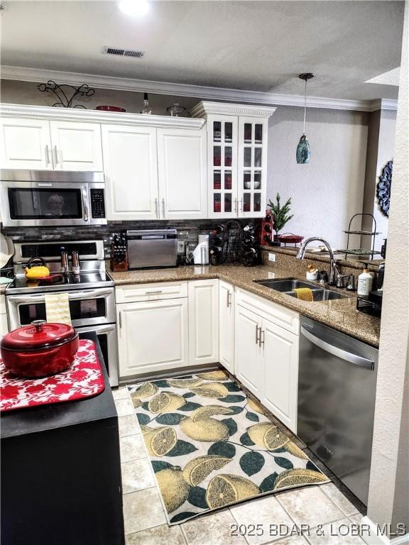 201 Marina Residence Dr Unit 3C, Camdenton, MO 65020 - kitchen featuring appliances with stainless steel finishes, a sink, ornamental molding, white cabinetry, and glass insert cabinets