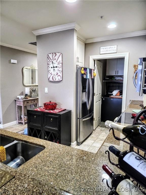 201 Marina Residence Dr Unit 3C, Camdenton, MO 65020 - kitchen with stainless steel fridge with ice dispenser, crown molding, white cabinetry, and dark stone countertops