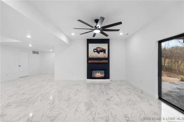 unfurnished living room featuring a large fireplace, recessed lighting, marble look tile flooring, ceiling fan, and baseboards