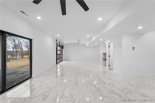 unfurnished room featuring ceiling fan, recessed lighting, marble finish flooring, and baseboards