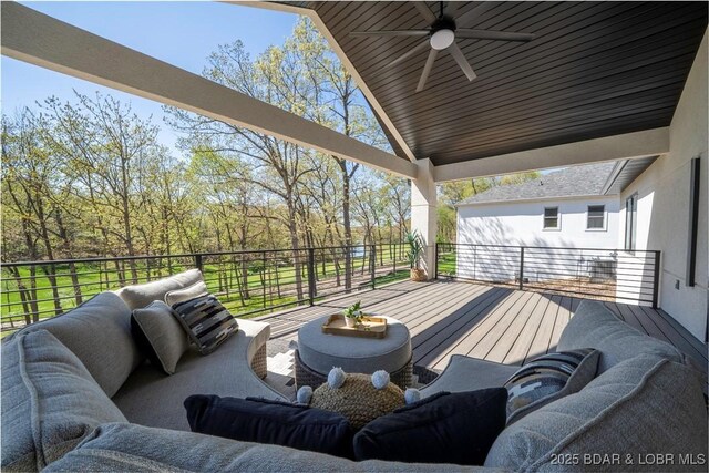 wooden deck featuring an outdoor living space and ceiling fan