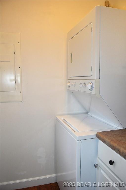 207 Circle Edge Unit 1A, Lake Ozark, MO 65049 - laundry area featuring estacked washer and dryer, electric panel, and cabinet space