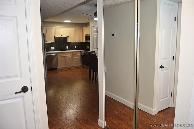 207 Circle Edge Unit 1A, Lake Ozark, MO 65049 - kitchen featuring appliances with stainless steel finishes, ceiling fan, dark wood-style floors, tasteful backsplash, and a textured ceiling