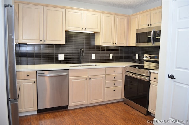 207 Circle Edge Unit 1A, Lake Ozark, MO 65049 - kitchen featuring appliances with stainless steel finishes, light countertops, wood finished floors, tasteful backsplash, and cream cabinets