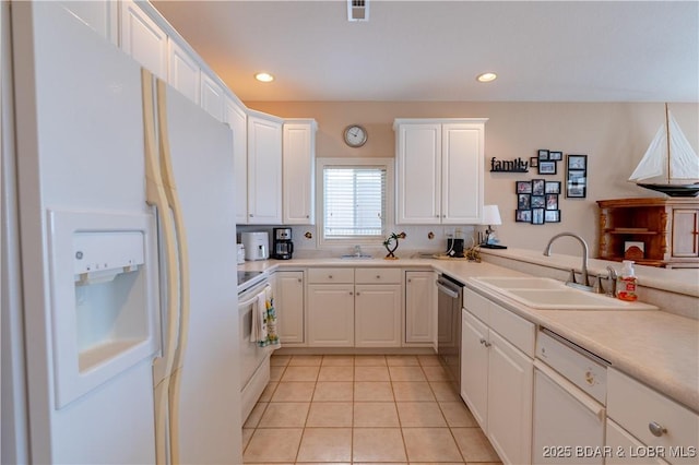 kitchen with light tile patterned floors, recessed lighting, white appliances, white cabinetry, and a sink