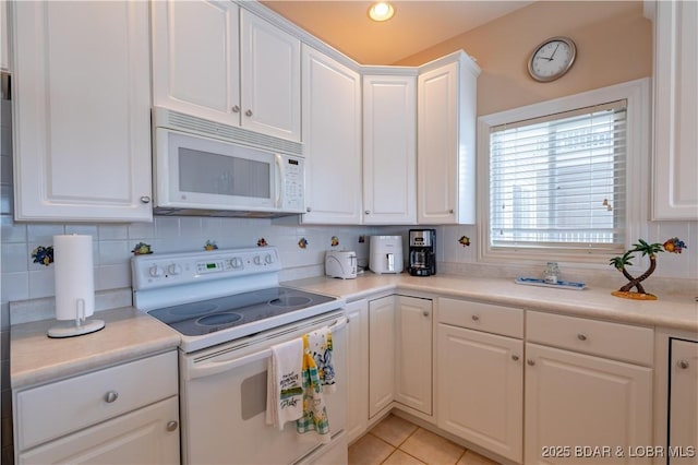 kitchen featuring white cabinetry, white appliances, and tasteful backsplash