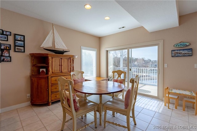 dining space with light tile patterned floors, visible vents, recessed lighting, and baseboards