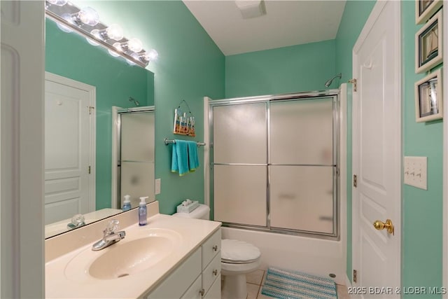 full bathroom with tile patterned flooring, toilet, vanity, and shower / bath combination with glass door