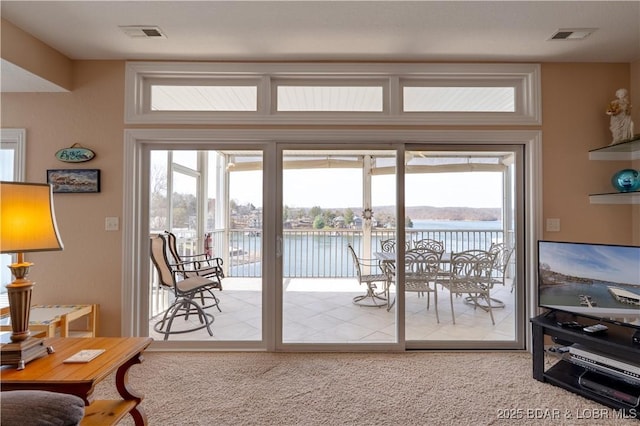 entryway featuring visible vents and carpet flooring
