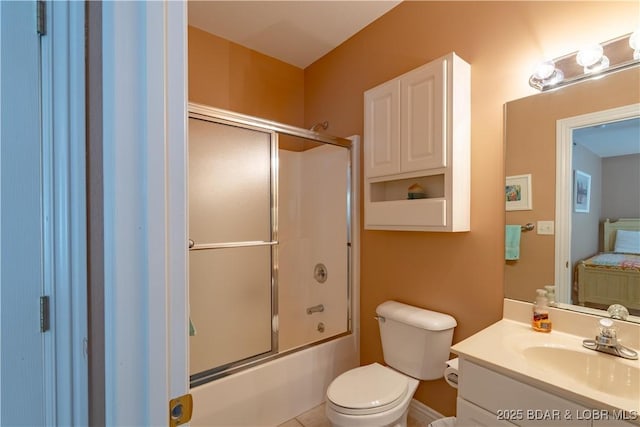full bathroom with vanity, toilet, and shower / bath combination with glass door