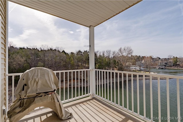 balcony with area for grilling and a water view