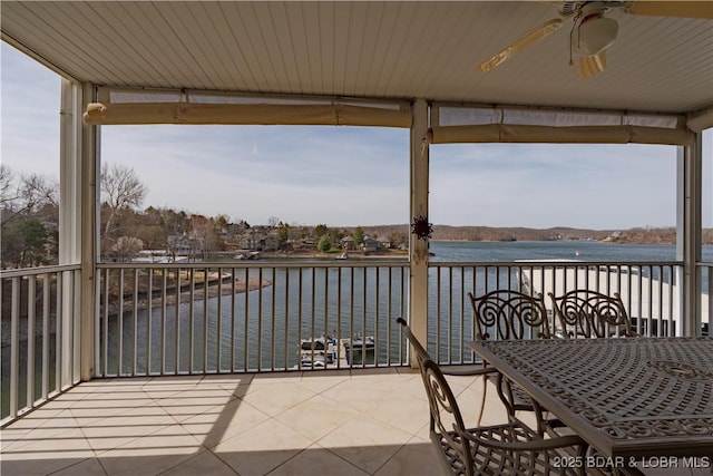 balcony with a water view and ceiling fan