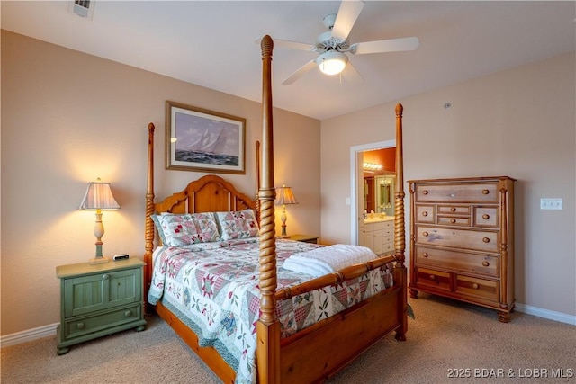 bedroom featuring connected bathroom, baseboards, light colored carpet, and ceiling fan