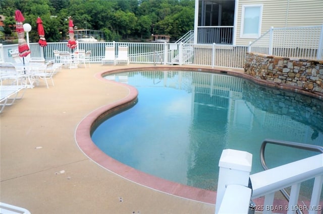 pool featuring a patio area and fence