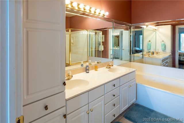 bathroom with a shower stall, double vanity, a tub to relax in, and a sink