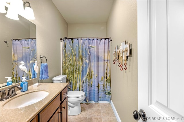 bathroom featuring vanity, toilet, and tile patterned floors